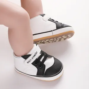 Detailed view of black and white baby prewalker shoes with adjustable Velcro strap