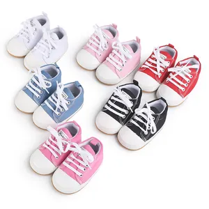 Variety of colorful newborn baby canvas shoes with soft rubber soles for first walkers