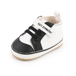 Detail of the black and white leather baby walker shoe with magic prewalker strap.