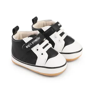 Close-up of black and white baby pre-walker shoes with magic prewalker velcro strap