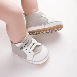 Detailed view of grey and white baby pre-walker shoes with soft soles worn by a baby