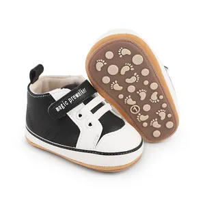 Close-up of black and white baby pre-walker shoes with soft anti-slip footprint soles