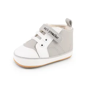Close-up of stylish grey and white baby prewalker shoes with magic prewalker strap