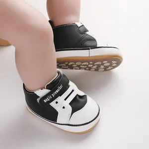 Close-up of stylish black and white infant walking shoes with magic prewalker strap.