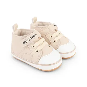Detail view of cream baby pre-walker shoes featuring the magic prewalker velcro strap