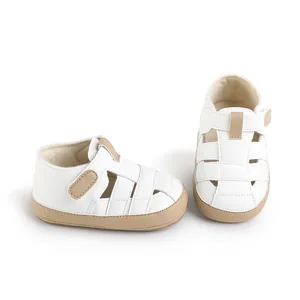 Minimalist white leather baby walker shoes with tan trim and hook-and-loop straps