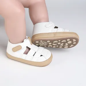 Close-up view of white baby pre-walker shoes featuring non-slip soles and velcro straps
