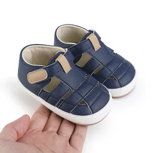 Premium dark blue faux leather baby walking sandals for 0-1 year olds shown in hand