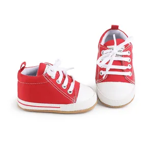 Detail view of red and white canvas baby pre-walker shoes with white laces