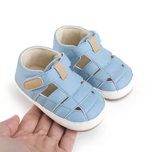 Soft-sole light blue baby walking sandals with breathable hollow design and velcro strap