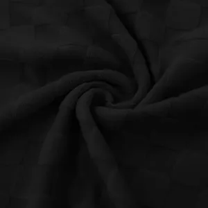 Close-up detail of black heavy jacquard fabric with classic checkerboard pattern