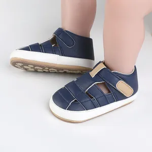 Detail of navy blue baby walking sandals with soft soles and hook-and-loop straps for infants