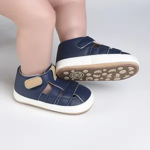 Close-up view of navy blue baby pre-walker shoes with non-slip patterned soft sole.