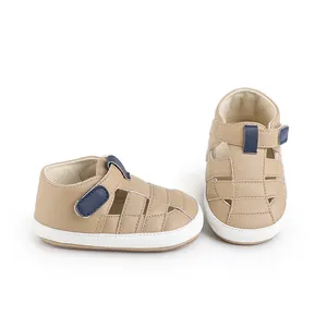 Detail view of tan faux leather infant walker sandals with blue velcro straps