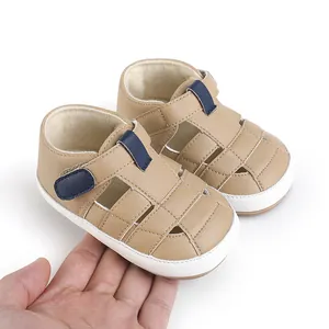 Close-up of beige infant walking shoes with navy blue velcro strap for 0-1 year olds