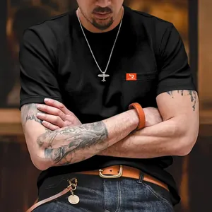 Vista detallada de la camiseta negra ajustada para hombre con etiqueta decorativa en el bolsillo.