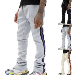 Men's stylish stacked flared sweatpants with side stripes in grey, black, and beige.