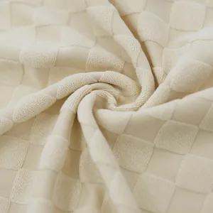 Close-up of beige jacquard checkerboard fabric showing textured knit and mesh detail