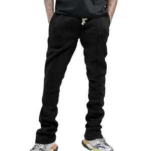 Detail of men's black slim fit flared sweatpants with vertical piping and drawstring waist.