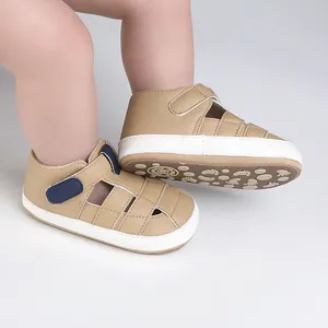 Detailed view of soft-sole khaki infant walking shoes with navy accents and velcro closure