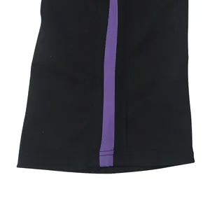 Close-up detail of black men's flared pants with a purple side stripe design