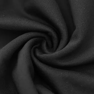 Close-up macro view showing the smooth black knit fabric texture of men's casual pants.