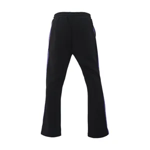 Detailed back view of men's black flared track pants featuring vibrant purple side stripes