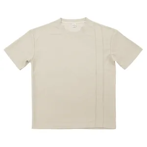 Detail view of beige waffle knit crewneck T-shirt showing texture and vertical seams.
