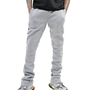 Close-up of men's slim fit grey joggers with side stripes and front seam details