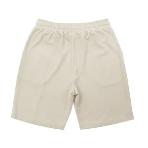 Back view detail showing texture of men's loose waffle knit shorts in minimalist beige
