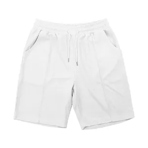 Macro view of white men's waffle knit shorts showing fabric texture and drawstring