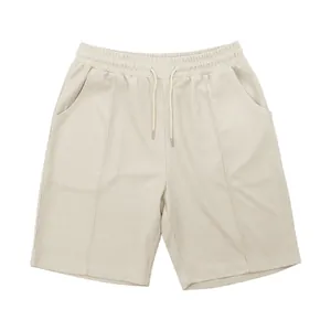 Detailed view of men's beige waffle knit leisure shorts with elastic drawstring waist.