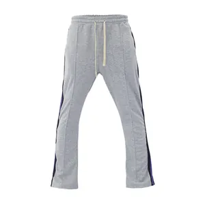 Front view of grey men's flared sweatpants featuring purple and black side stripes.