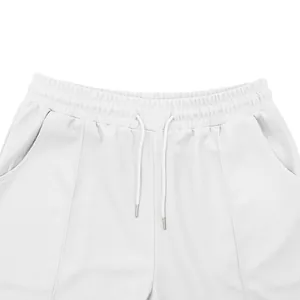 Close-up of white waffle knit shorts with elastic drawstring waist and side pockets.