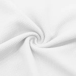 Detailed macro shot of white waffle knit fabric texture with breathable grid pattern