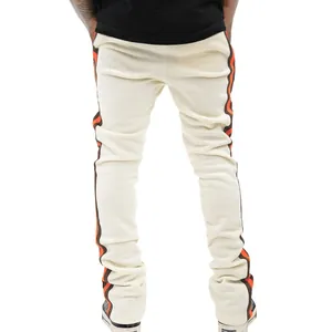 Slim fit cream casual pants with wavy orange and brown side stripes for men