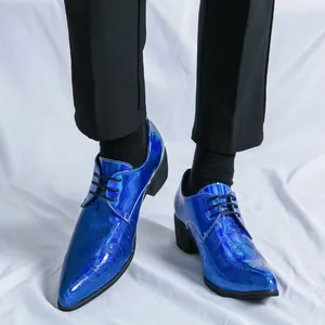 Detail showing blue patent leather pointed-toe shoes with embossed pattern and high heel.