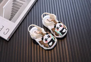 Close-up view of toddler walking sandals featuring cute cartoon panda and bamboo motifs.