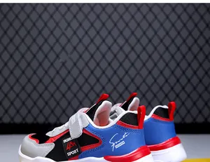 Close-up detail of boys' lightweight breathable mesh sneakers in blue and red colorway