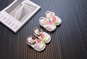 Detailed view of cute cartoon rabbit baby girl sandals in pink and brown colors