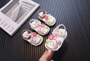 Close-up of cute cartoon rabbit baby sandals in various colors for toddler girls walking