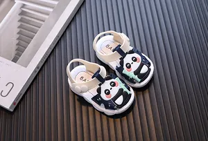 Detailed view of navy blue baby sandals featuring a cute cartoon panda and soft sole design