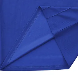 Close-up view of the breathable blue waffle knit fabric and durable hem stitching.