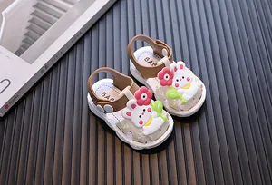 Close-up view of baby girl sandals featuring a cute 3D cartoon rabbit and flower design.