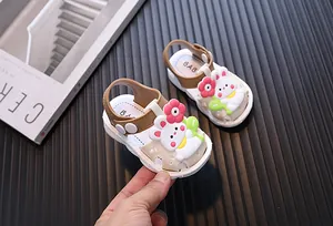 Close-up detail of cute toddler girl sandals featuring cartoon rabbit and flower charms
