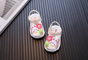 Detail of baby girl summer sandals with cute cartoon rabbit decoration