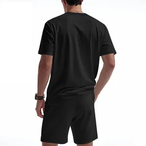 Back view of a men's black waffle knit t-shirt and shorts two-piece summer outfit.