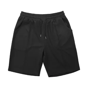Detailed view of men's black waffle texture shorts featuring an elastic drawstring waistband.