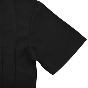 Close-up detail of premium black waffle knit fabric texture on men's short sleeve shirt.