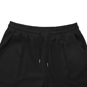 Detailed close-up of black waffle knit shorts with drawstring waistband texture